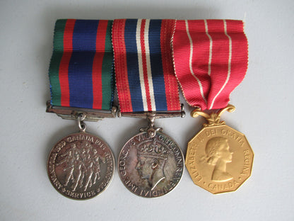 CANADA GROUP OF 3 WWII MEDALS ON MEDAL BAR. NAMED TO CPL. J.G. McCAFFREY. IN ORIGINAL CASE.